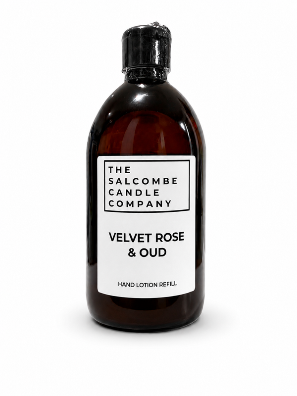 An amber bottle of hand lotion refill by The Salcombe Candle Company, labeled 'Velvet Rose & Oud', on a white background.