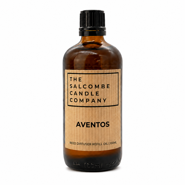 A 100mL amber glass bottle of Aventos reed diffuser refill oil by The Salcombe Candle Company, featuring a light wood-grain label and a black cap, set against a plain white background.