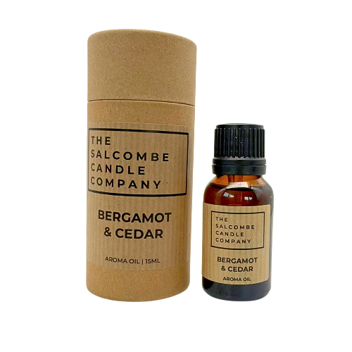 Bottle and cylindrical container of Bergamot & Cedar aroma oil from The Salcombe Candle Company on a white background