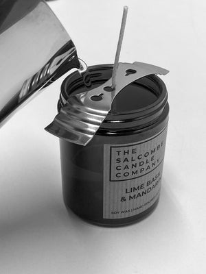 Candle being poured featuring 'The Salcombe Candle Company' label.