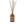 Aromatherapy diffuser with ratten reeds and an amber glass bottle on a white background.