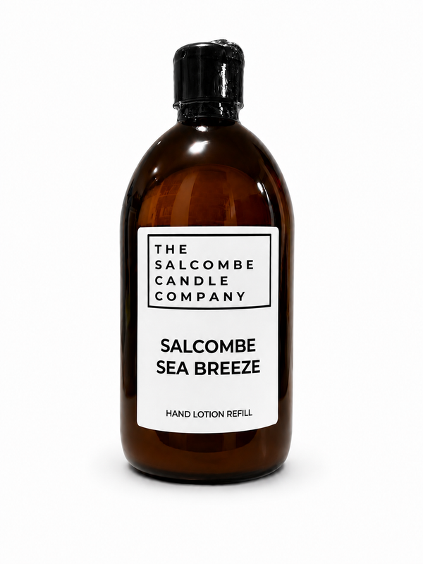 An amber bottle with a black cap and a white label reading 'THE SALCOMBE CANDLE COMPANY' and 'SALCOMBE SEA BREEZE HAND LOTION REFILL', photographed on a clean white background.